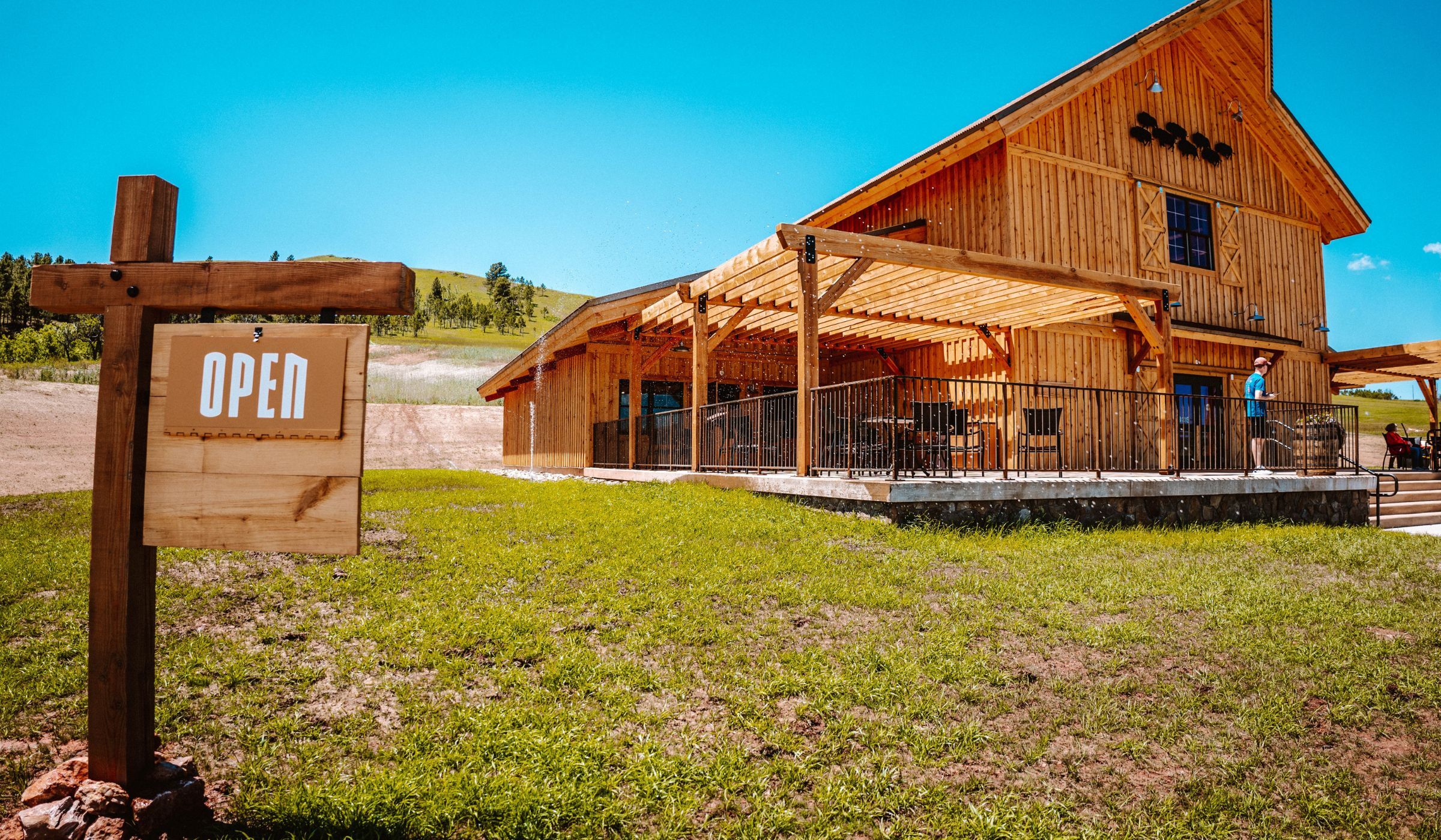 Open sign in yard in front of Bison Center