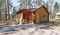 Cabin sits under pine trees in Blue Bell Lodge area at Custer State Park