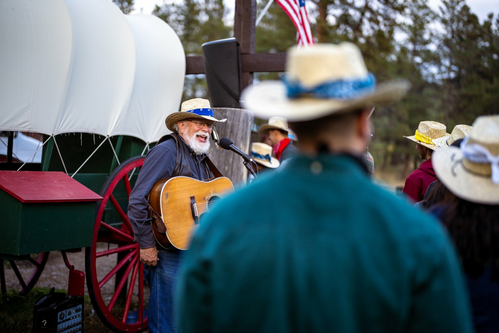 Musician singing to crowd while holding a guitar