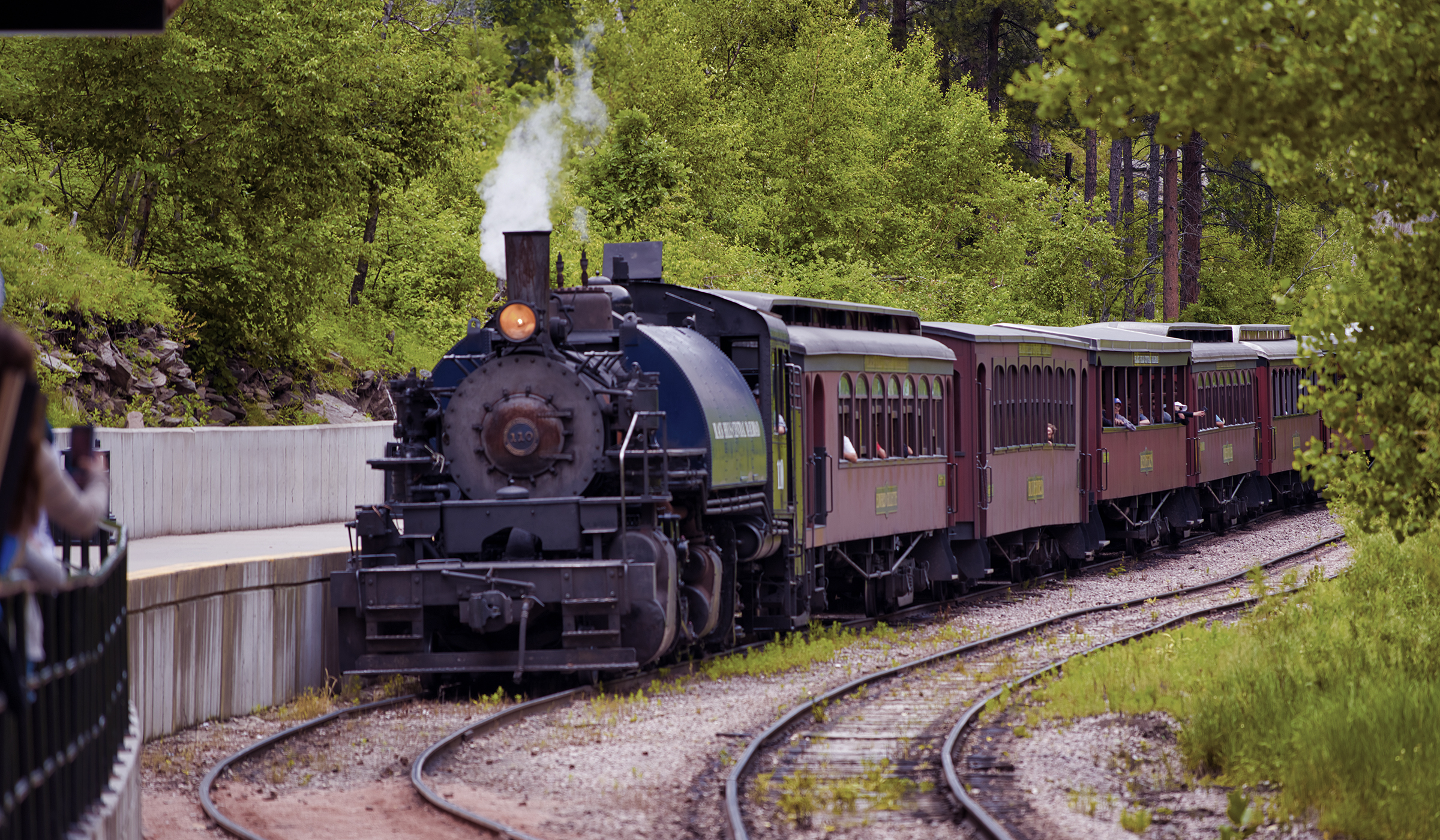 Front of a train that is moving through Custer State Park