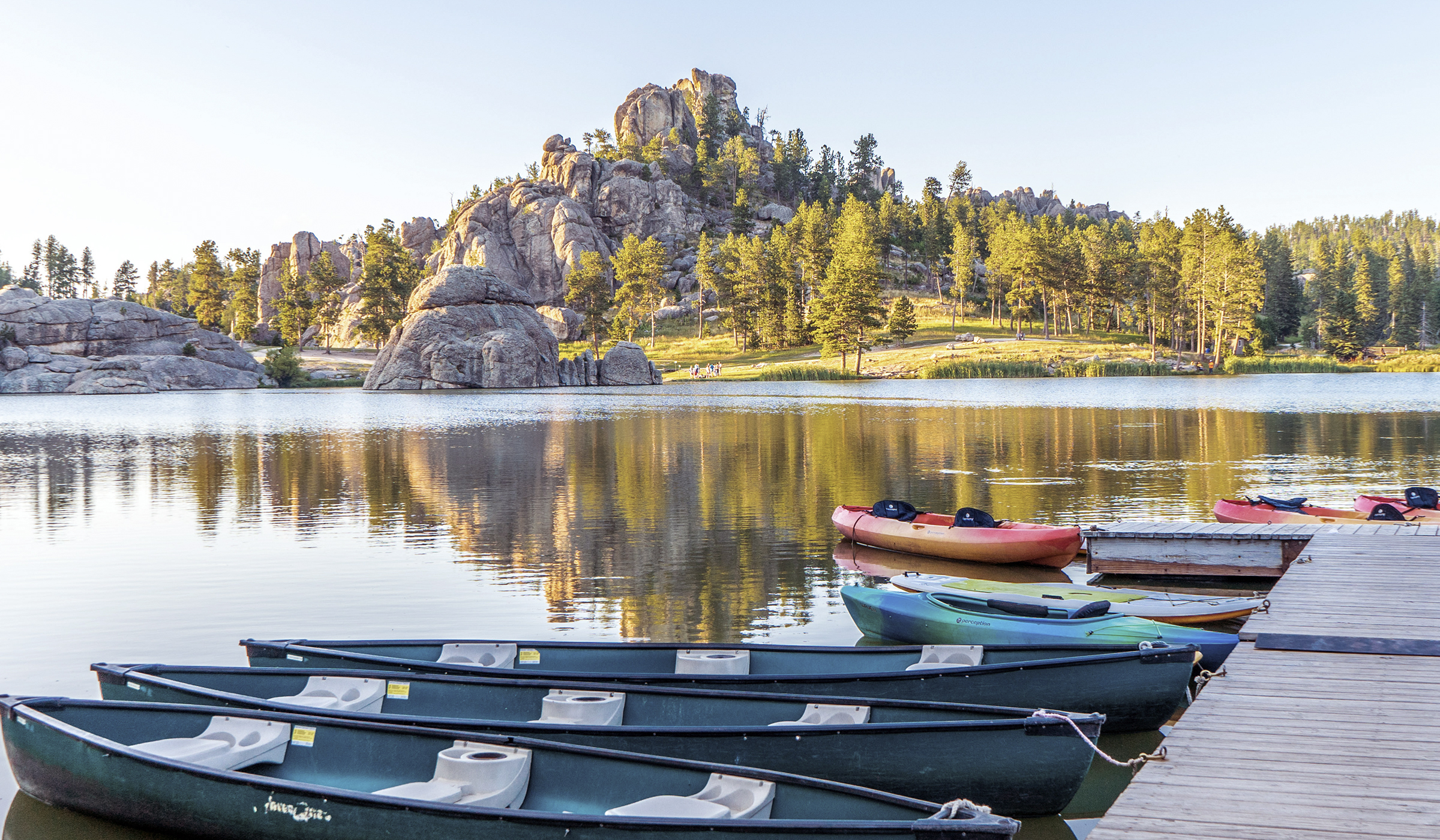 Dock on the lake with mountains in the background