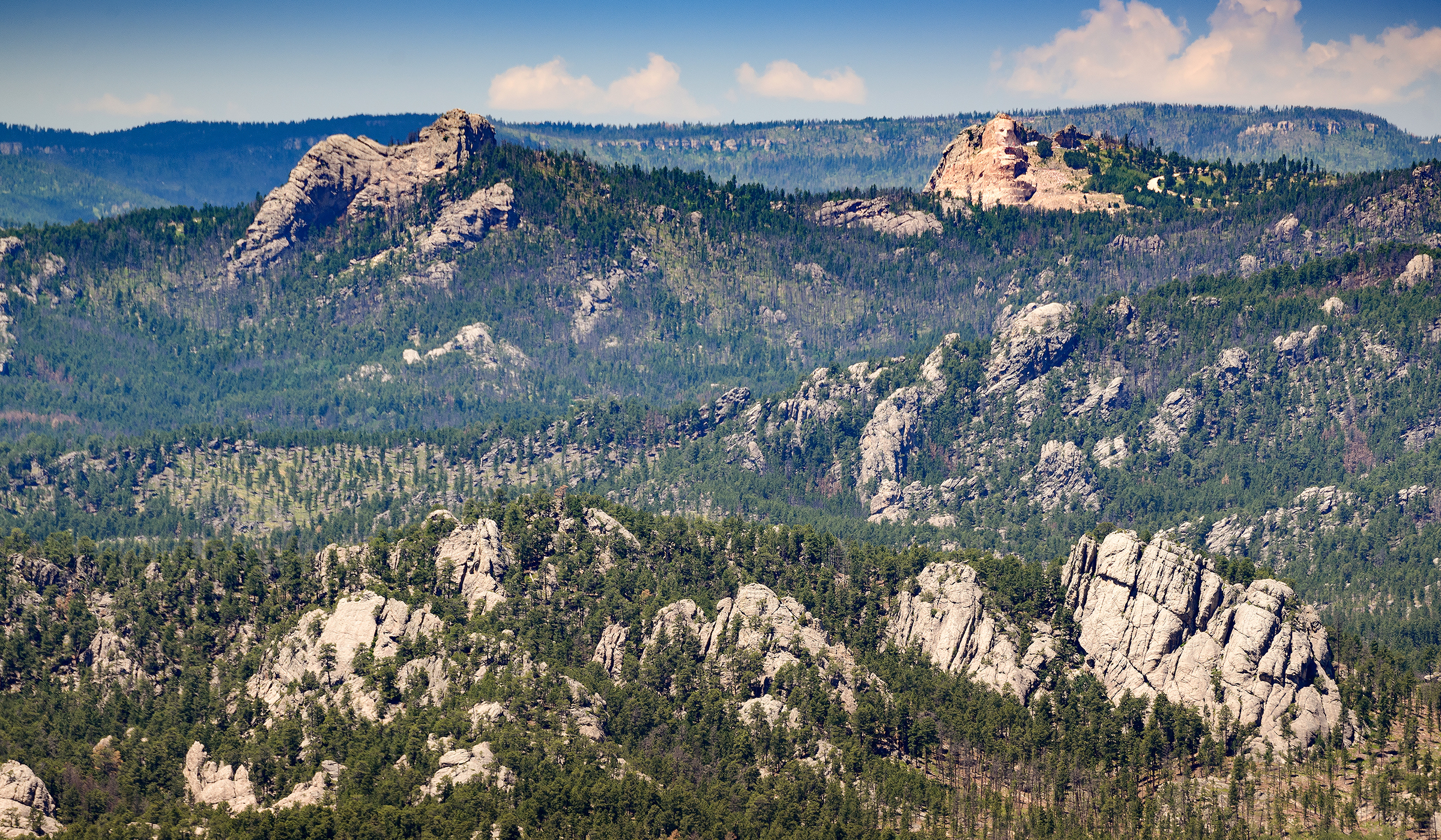 Aerial shot of mountains with Crazy Horse in the background