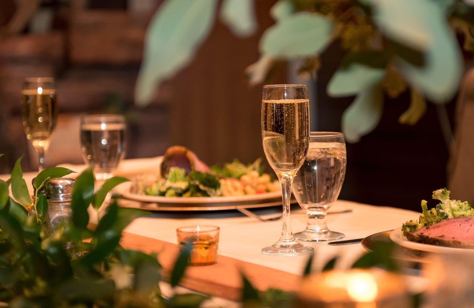 Plated dinner with glasses of water and champagne