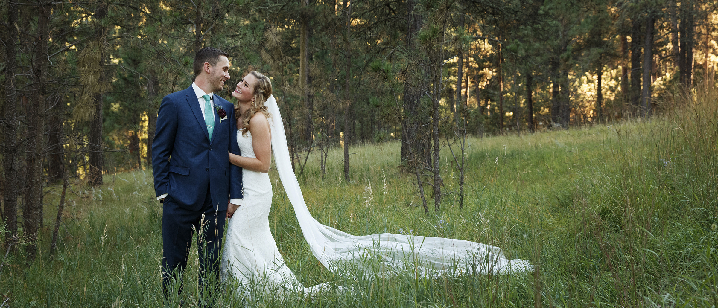 Bride and groom posing for wedding pictures outside
