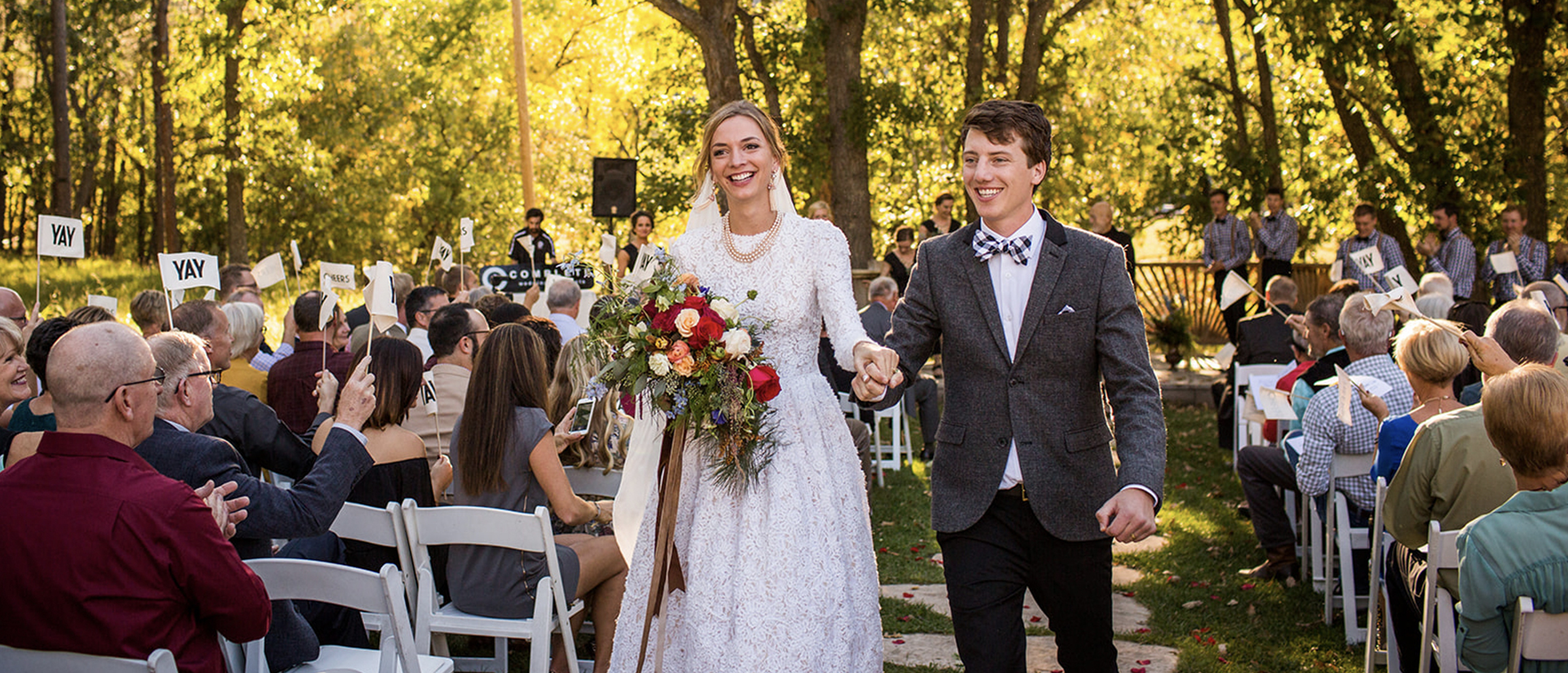 Bride and groom walking down the aisle at an outdoor wedding