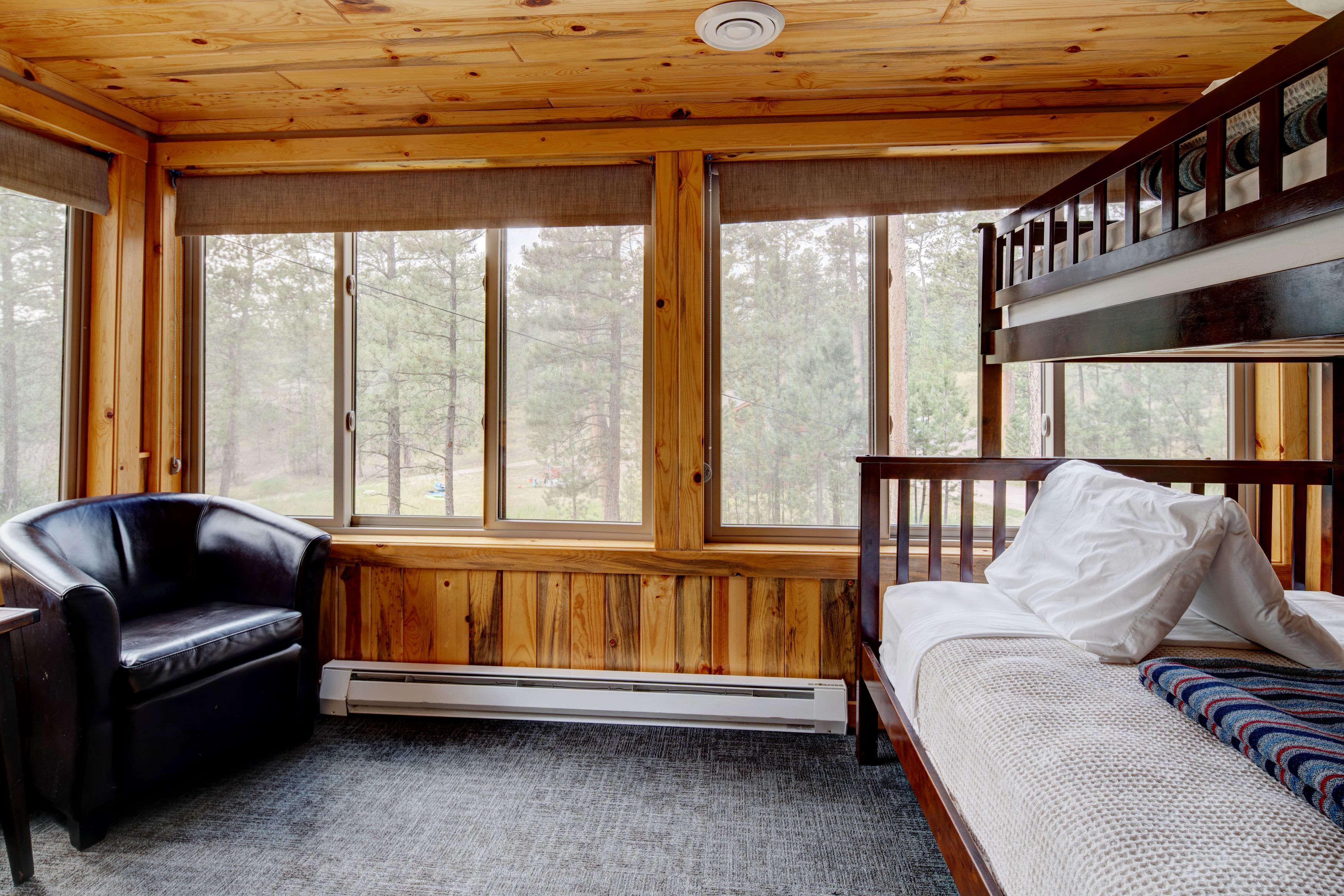 interior of lodge with bunk bed and chair in bedroom