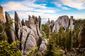 View of hills and mountains with a forest at the base. This is Needles Highway